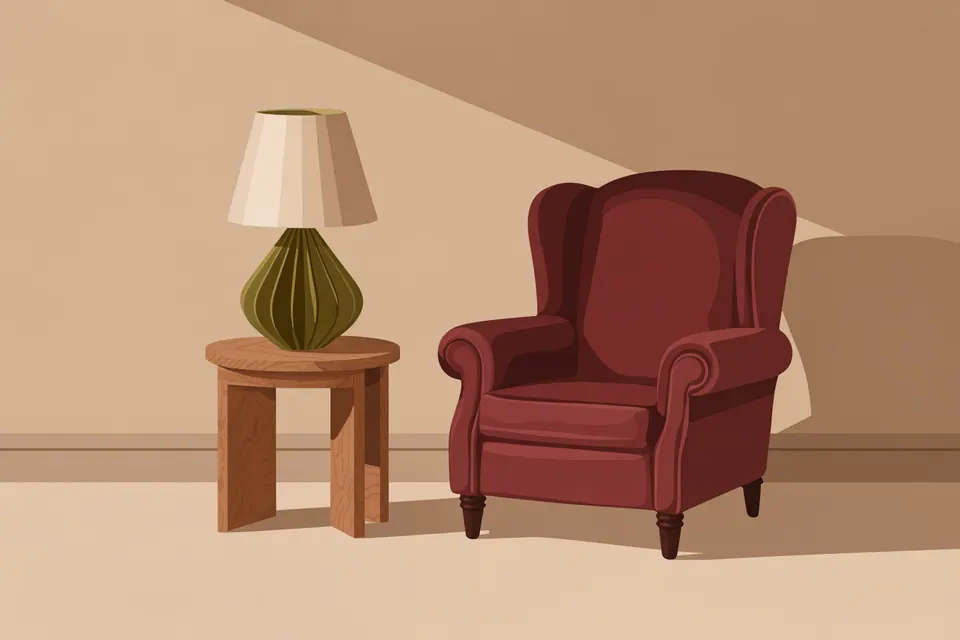 A burgundy wingback chair beside a wooden table and a green lamp.